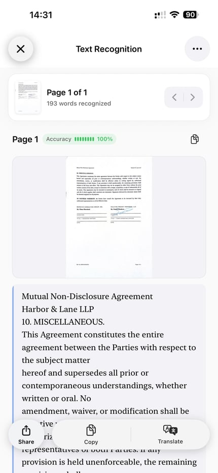 ScanLens on iPhone showing a scanned page beside its recognized text, ready to correct and copy